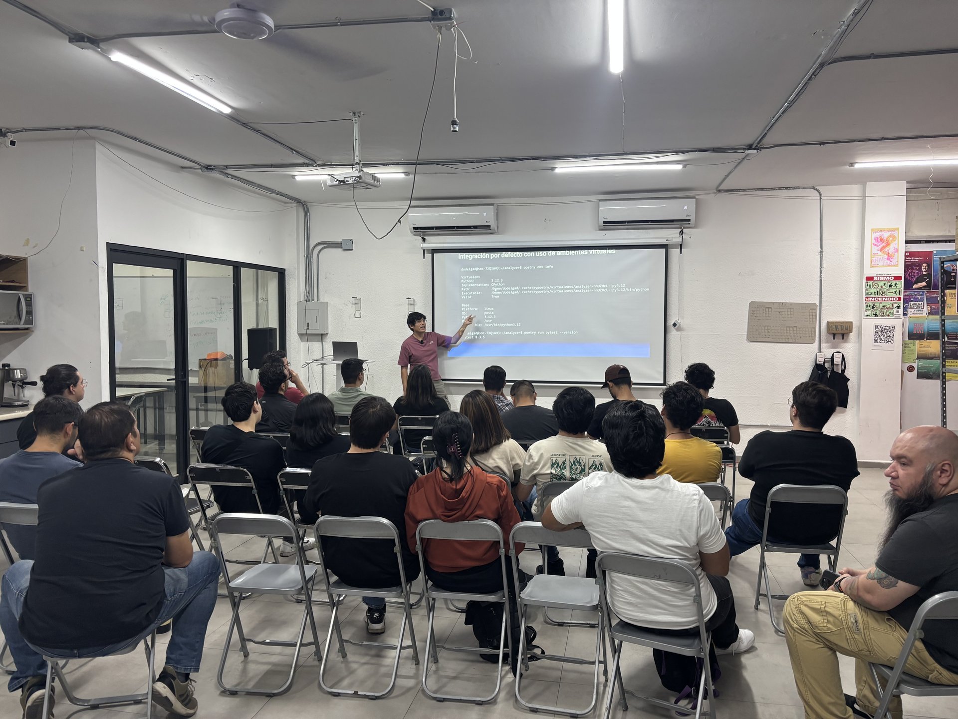 Audiencia atenta durante la explicación de Poetry y sus beneficios